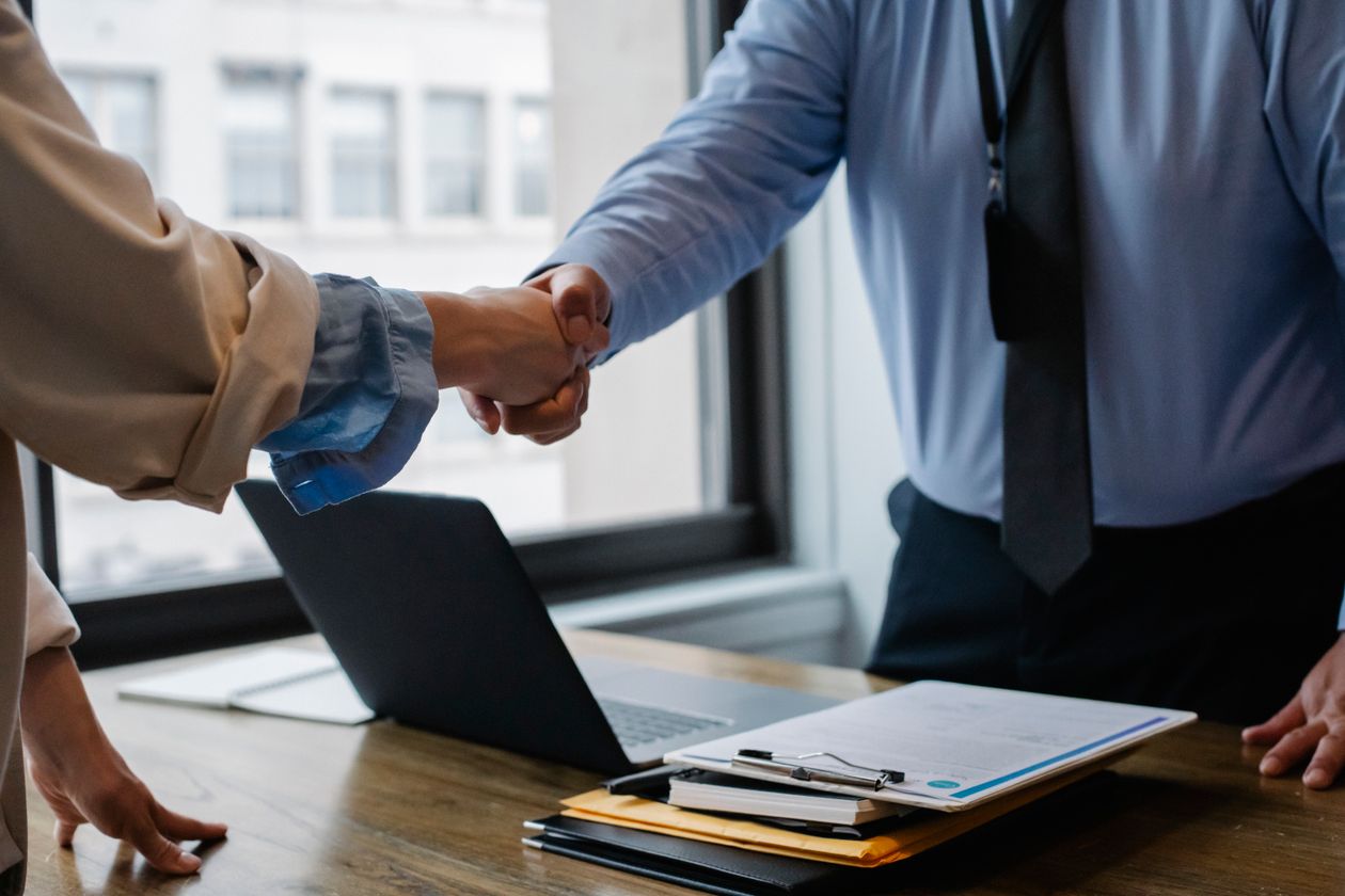 A handshake across a desk after a meeting